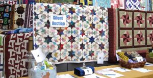 photo of quilts and silent auction items