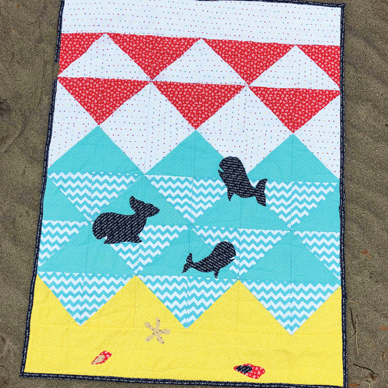  photo of a youth quilt project with half square triangles and whale 