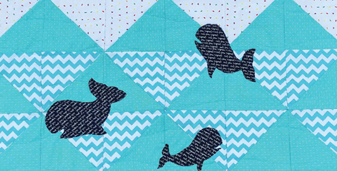 : photo of a youth quilt project with half square triangles and whale