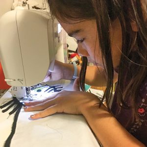 photo of kyla farquharson sewing her family quilt