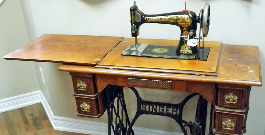 photo of singer 27 antique sewing machine in a stand 