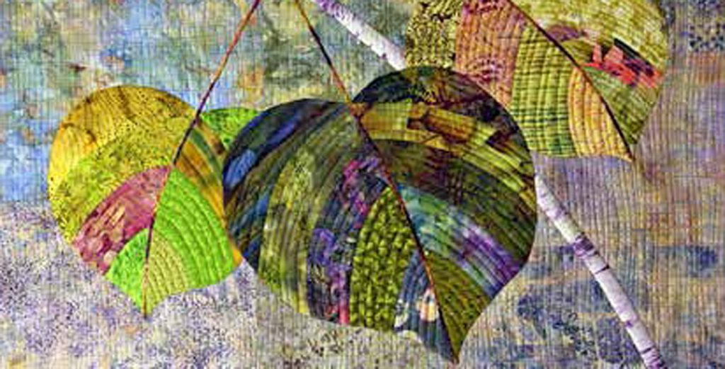 photo of a quilt with three leaves on a branch