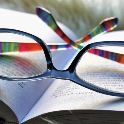 photo of reading glasses on an open book