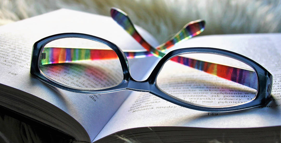photo of reading glasses on an open book
