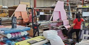 photo of fabric being doubled and rolled